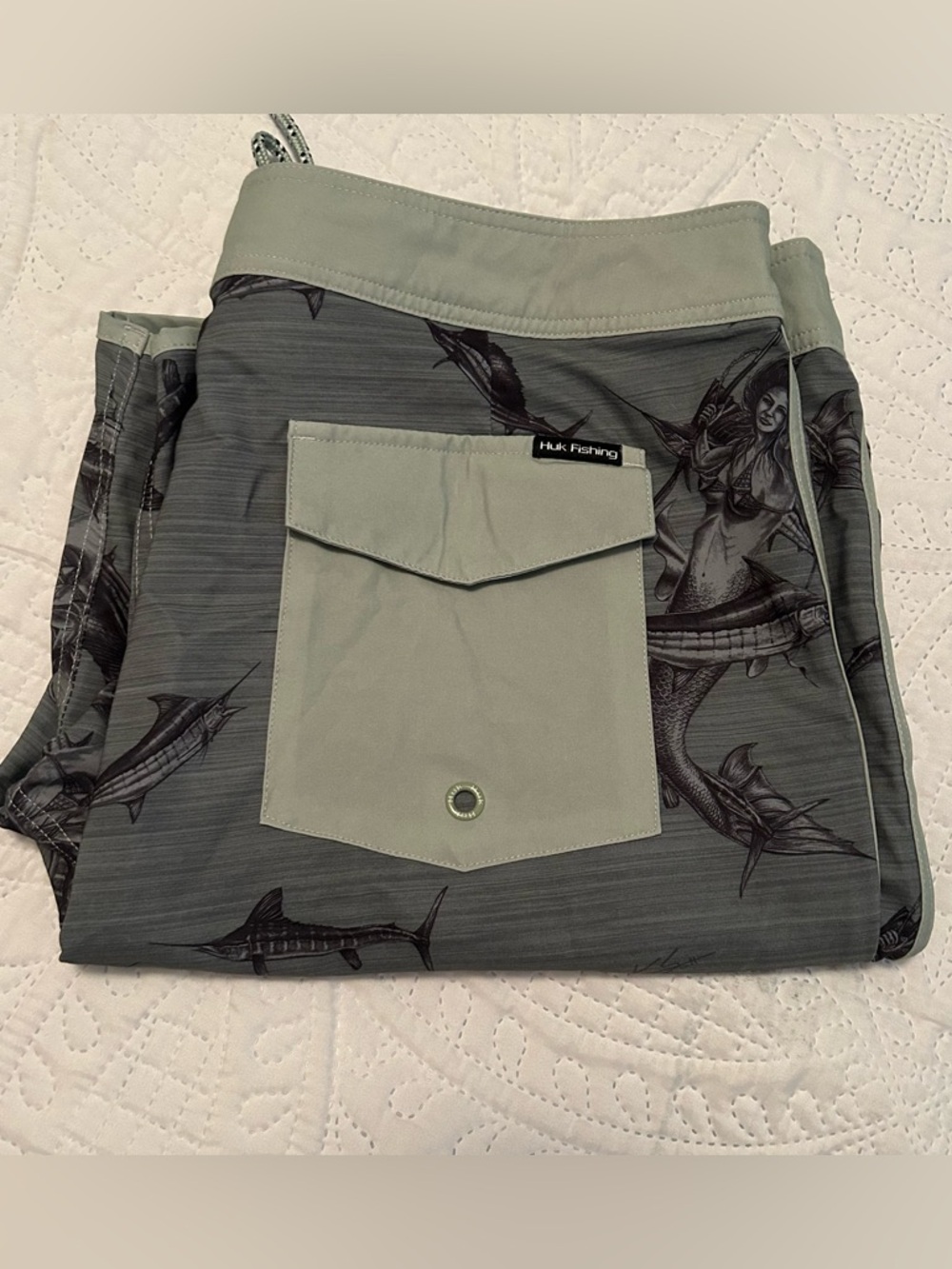Huk Performance Fishing Green Board Shorts with Mermaid/Marlin Graphics